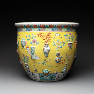 A Chinese famille rose yellow-ground relief-molded 'antiquities' fish bowl, Zhengde mark, 19th C.