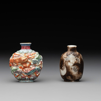 A Chinese famille rose molded 'Buddhist lions' and a grisaille 'dragon' snuff bottle, Qianlong and Daoguang mark, 19th C.