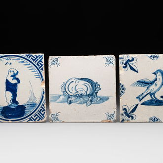 Three blue and white Dutch Delft tiles with a bear, a crab and a bird, 17th C.