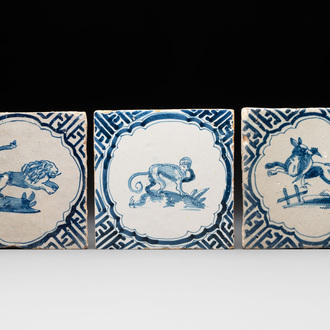 Three blue and white Dutch Delft tiles with a monkey, a lion and a fox with their prey, 17th C.
