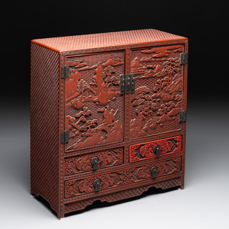 A Chinese cinnabar lacquer 'mountainous landscape' cabinet, 19th C.