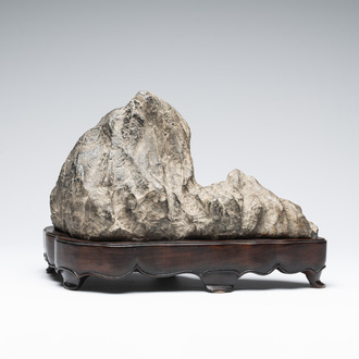 A Chinese Lingbi stone scholar's rock on wooden stand, 20th C.