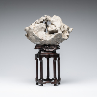 A Chinese Taihu stone scholar's rock on wooden stand, 20th C.