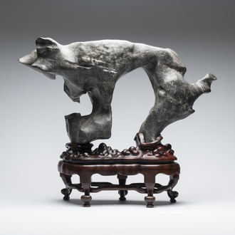 A large Chinese Lingbi stone scholar's rock on wooden stand, 19/20th C.
