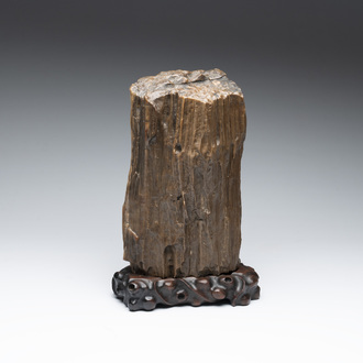 A Chinese petrified wood scholar's rock on wooden stand, 17/18th C.