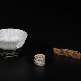 A Chinese jade 'chrysanthemum' bowl, an archer's ring and a belt hook, Ming/Qing