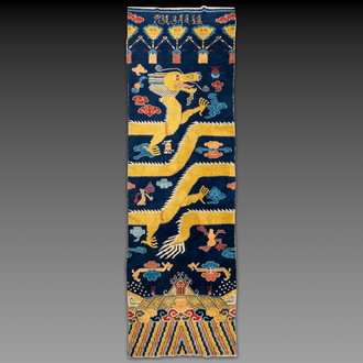 A Chinese inscribed woollen 'dragon' pillar carpet, 19th C.