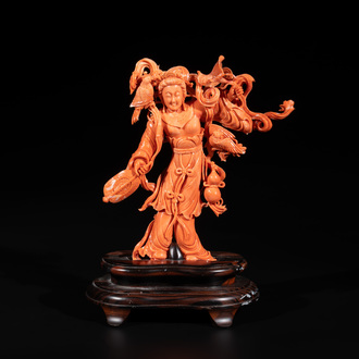 A Chinese red coral Xiwangmu on wooden stand, 19/20th C.