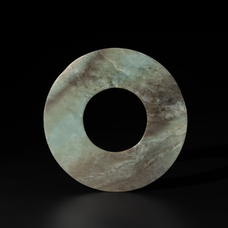 A Chinese celadon and russet jade 'bi' disc, Neolithic period