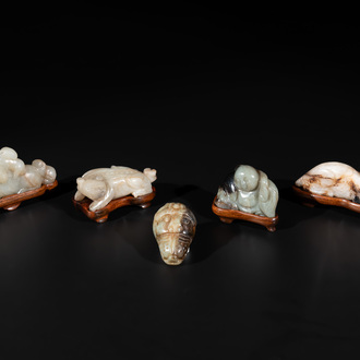 Five Chinese jade carvings with four wooden stands, 19th C.