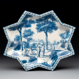 A rare blue and white Dutch Delft star-shaped dish with travellers in a landscape, early 18th C.