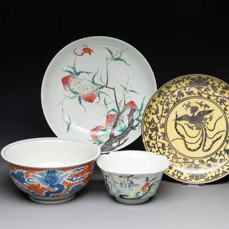 A Chinese famille rose bowl, a 'peaches' plate, a blue and white and iron-red bowl and a 'phoenix' plate, Wanli and Jiaqing marks, 19th C.