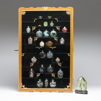 A Chinese gilt-lacquered wall display cabinet and a collection of various snuff bottles, stands and carvings, 20th C.