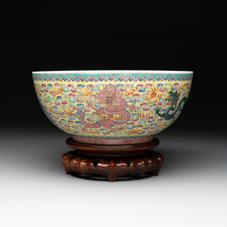 A Chinese famille rose turquoise-and-yellow-ground 'dragon' bowl on wooden stand, Qianlong mark, Republic