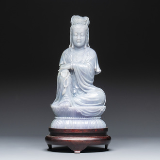 An exceptional and large Chinese carved pale lavender jadeite Guanyin on a wooden stand, Republic
