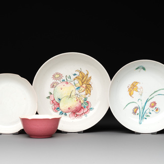 Three Chinese ruby-ground famille rose plates and a cup, 19th C.