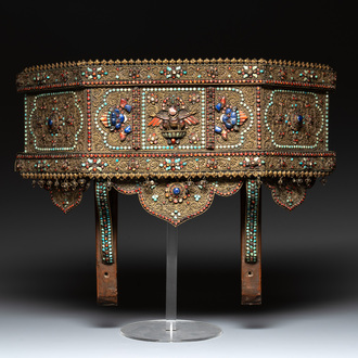 A Nepalese gilt copper console inlaid with glass, precious stones and red coral, 19th C.