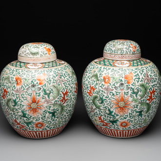 A pair of Chinese famille verte 'lotus scroll' jars and covers, 19th C.