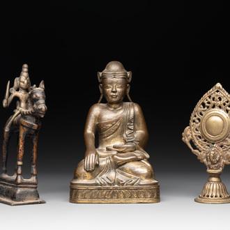 A Burmese gilt bronze Buddha, an Indian bronze Shiva on horseback and and a Nepalese Melong ritual mirror with Ganesh, 18/19th C.