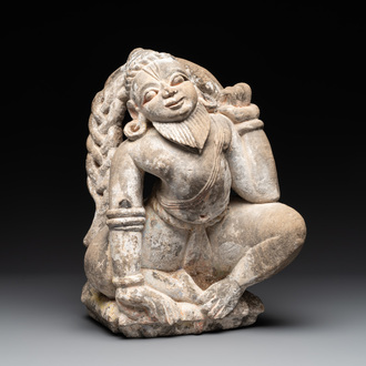 An Indian polychromed stone sculpture of a deity, 18/19th C.
