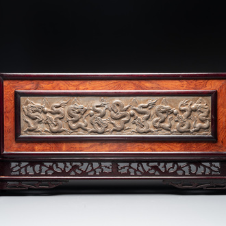 A Chinese wooden table screen with a carved stone 'dragon' plaque, 20th C.