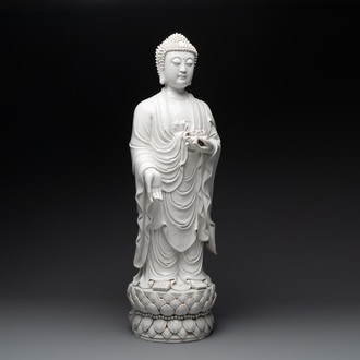 A large Chinese Dehua blanc de Chine figure of Buddha holding a lotus, He Chaozong 何朝宗 and Dehua 德化 mark, 20th C.