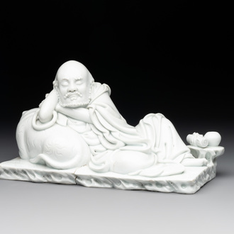 A Chinese Dehua blanc de Chine figure of a Luohan reclining on a tiger, Dehua and Bo Ji Yu Ren 博及漁人 mark, 20th C.