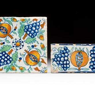 A polychrome and a 'border' Dutch Delft tile with pomegranates and grapes, 1st half 17th C.
