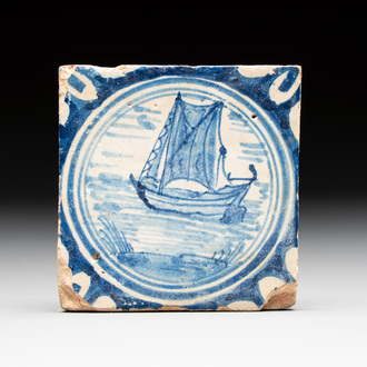 A small blue and white Dutch Delft 'boat' medallion tile, late 16th C.