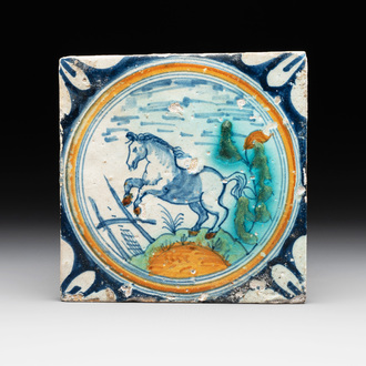 A polychrome Dutch Delft maiolica 'horse' medallion tile, late 16th C.