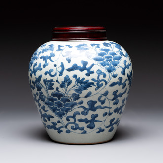 A Chinese blue and white 'peony scrolls' vase and wooden cover, Transitional period