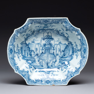 A blue and white Dutch Delft basin with putti near a fountain, 18th C.