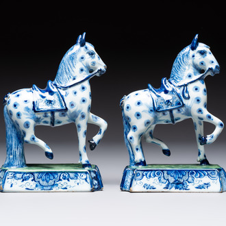 A pair of blue and white Dutch Delft prancing horses on a green-glazed base, 18th C.