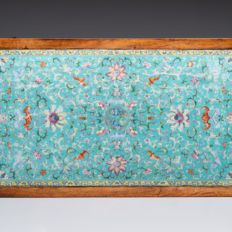 A Chinese famille rose turquoise-ground 'flower scrolls and bats' plaque, later mounted as table, Qianlong