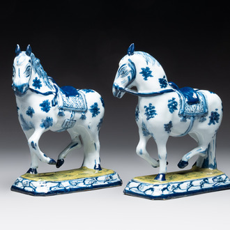 A fine pair of blue and white Dutch Delft horses on a green base, 18th C.