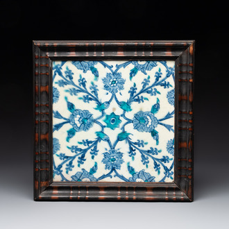 A framed blue, white and turquoise Iznik pottery tile with floral design, Turkey, 17th C.