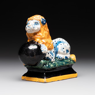 A rare black-ground polychrome Dutch Delft model of a lion with a ball, 18th C.