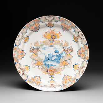 A polychrome Dutch Delft mixed technique dish with a fine landscape, 18th C.