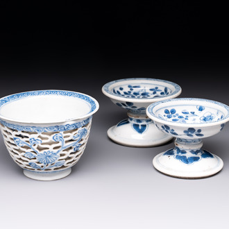 A pair of Chinese blue and white salts and a reticulated double-walled cup, Kangxi
