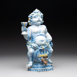 A polychrome Dutch Delft table fountain in the shape of Bacchus on a barrel, early 18th C.