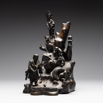 A rare Chinese bronze group depicting two immortals and various animals in a mountainous landscape, Ming