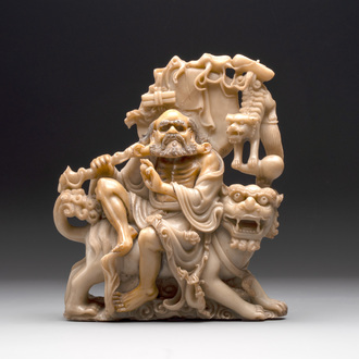 A Chinese carved group of a Luohan with two tigers, 20th C.
