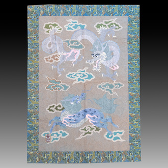 A Japanese embroidered wool and silk wall tapestry with a dragon and qilin, Meiji, 19th C.