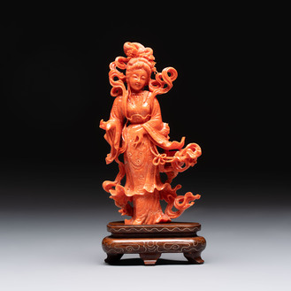 A Chinese red coral figure of a goddess on wooden stand, 19/20th C.
