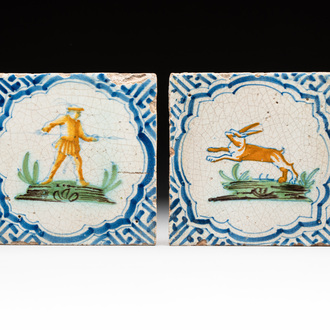 Two polychrome Dutch Delft 'accolade borders' 'hunter' and 'hare' tiles, 17th C.