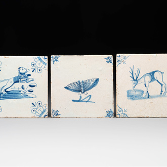 Three blue and white Dutch Delft tiles with a lion, a butterfly and a deer, 17th C.