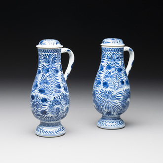 A pair of Chinese blue and white jugs and covers with floral design, Kangxi