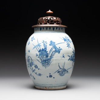 A Chinese blue and white vase with floral design and wooden cover, Transitional period