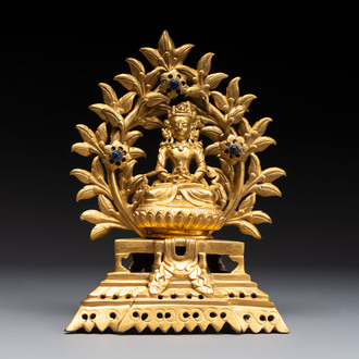A Nepalese gilt-bronze Buddha on an inscribed throne with a mandorla, 19th C.