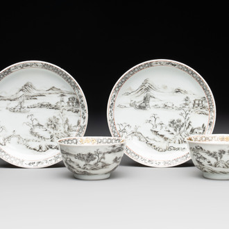 A pair of Chinese grisaille and iron-red 'landscape' cups and saucers, Yongzheng/Qianlong